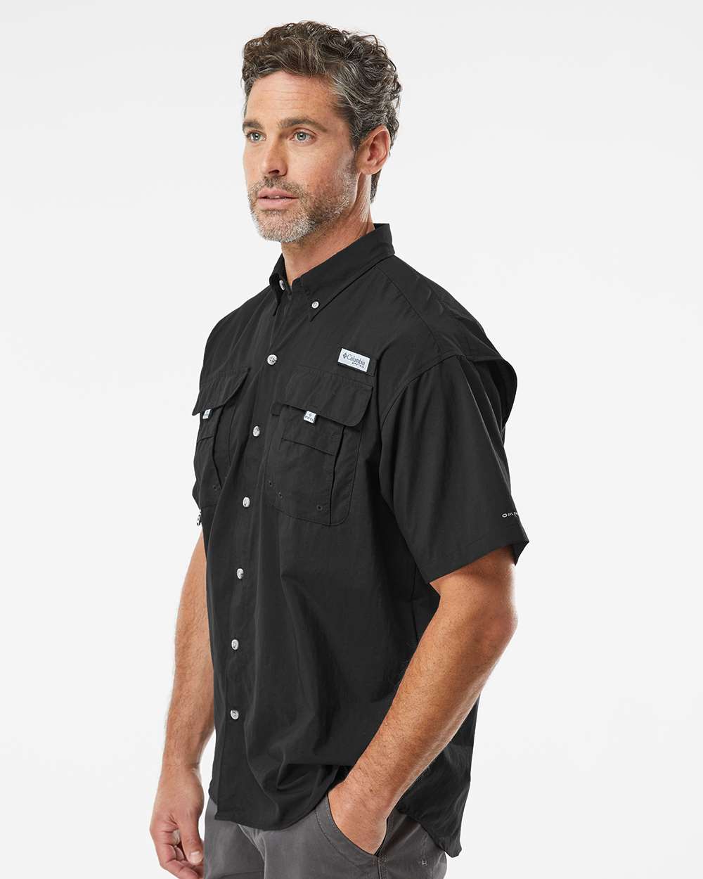 Man wearing a black short-sleeve shirt with button details on a white background