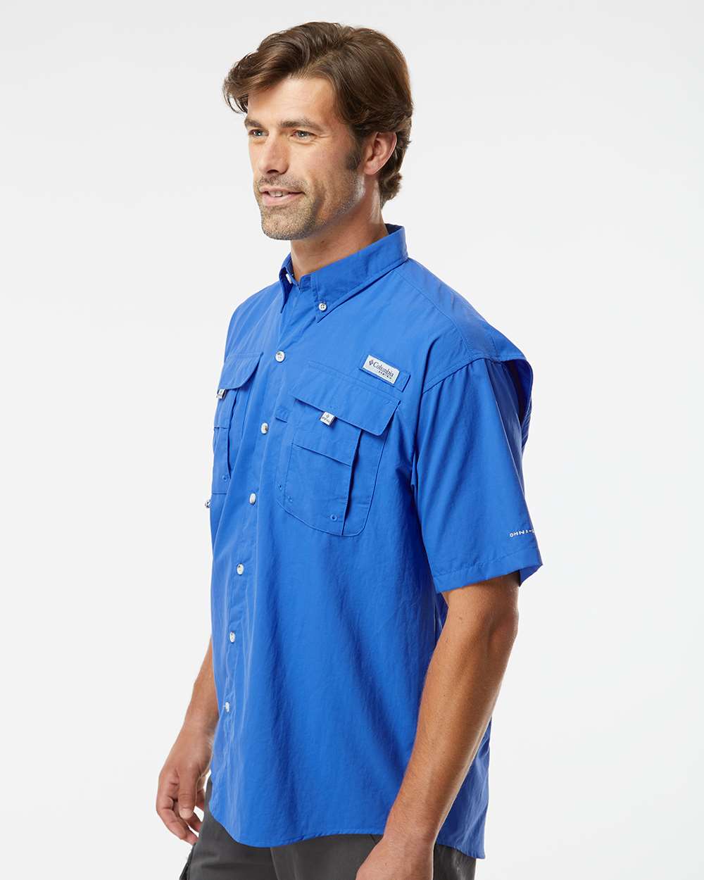 Man wearing a blue short-sleeve shirt on a white background